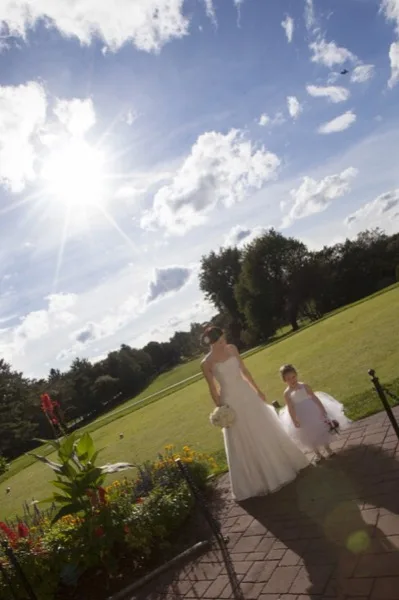 Bride and flower girl on Bellevue Golf Club grounds